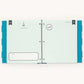 An open ring-bound planner or album with pale mint pages, teal polka-dot side panels, and printed stationery inserts, photographed against a plain white background.
