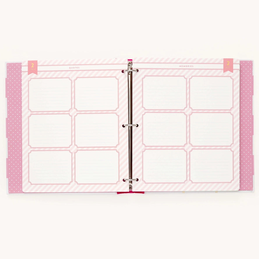 A pink and white ring binder planner insert set with nine blank lined boxes and decorative striped and polka-dot borders, shown open on a light background.