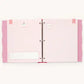A light pink binder with three rings, featuring decorative pink side tabs, a blank white text box on the left page, and small circular inserts, shown against a plain off-white background.