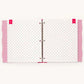 A white ring binder notebook with a delicate pink dotted pattern on the pages, featuring pink ribbon covers on the left and right sides and a silver metal ring closure in the center.